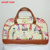 A small beige and pink patterned PU leather travel duffel bag with a brown handle.