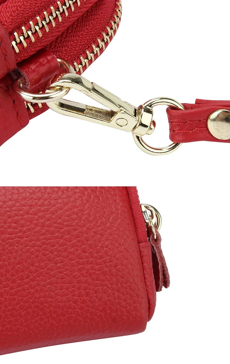 Close-up of a red genuine cowhide leather double-zip wristlet wallet with gold hardware.