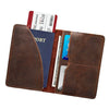 A brown genuine leather passport wallet displaying a passport and various card holders.