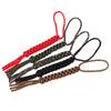 A set of seven-strand paracord ropes in red, green, black, and brown are displayed as keychains or utility ropes.