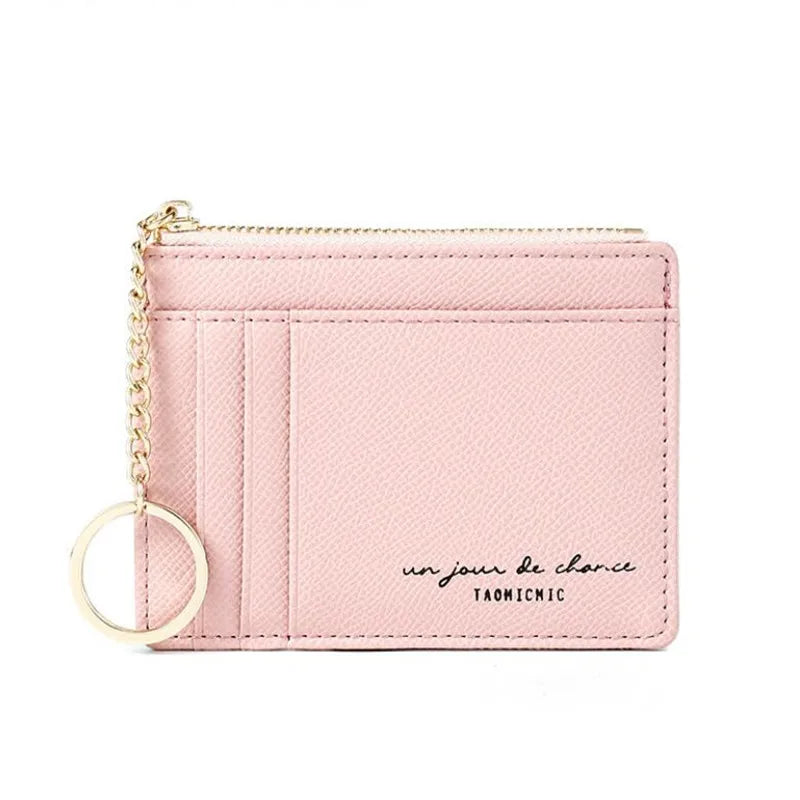 A pink compact PU leather zip wallet with a gold chain keychain.