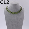 A close-up of a green acrylic link chain necklace displayed on a mannequin neck.