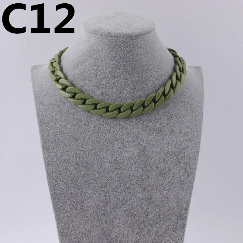 A close-up of a green acrylic link chain necklace displayed on a mannequin neck.