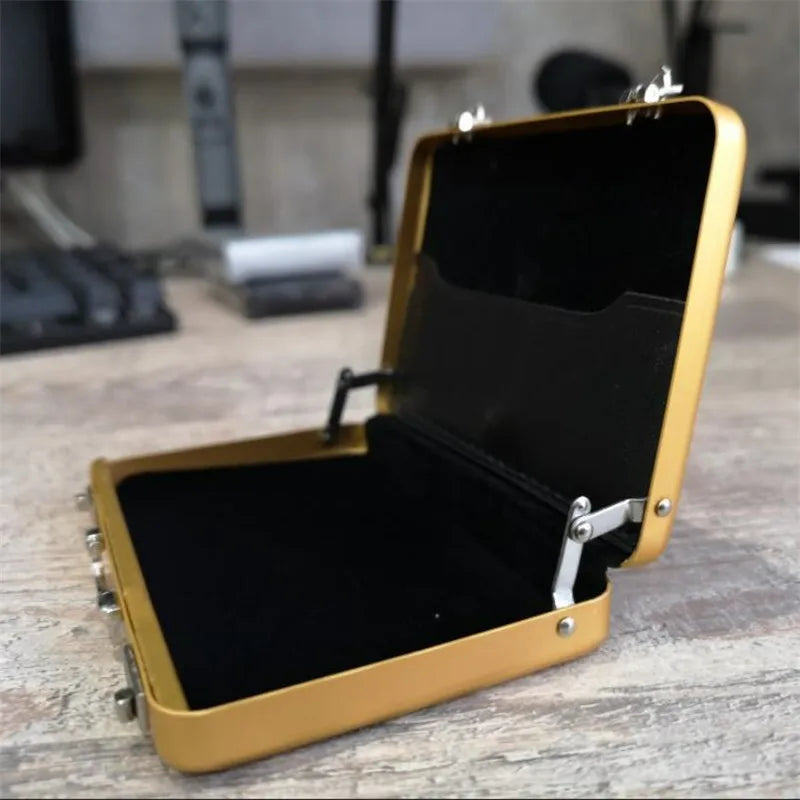 A gold-colored aluminum credit card and ID holder case is shown open on a wooden surface.