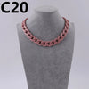 A close-up of a pink acrylic link chain necklace displayed on a gray mannequin neck.