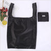 A black eco-friendly foldable shopping bag is shown against a white background.