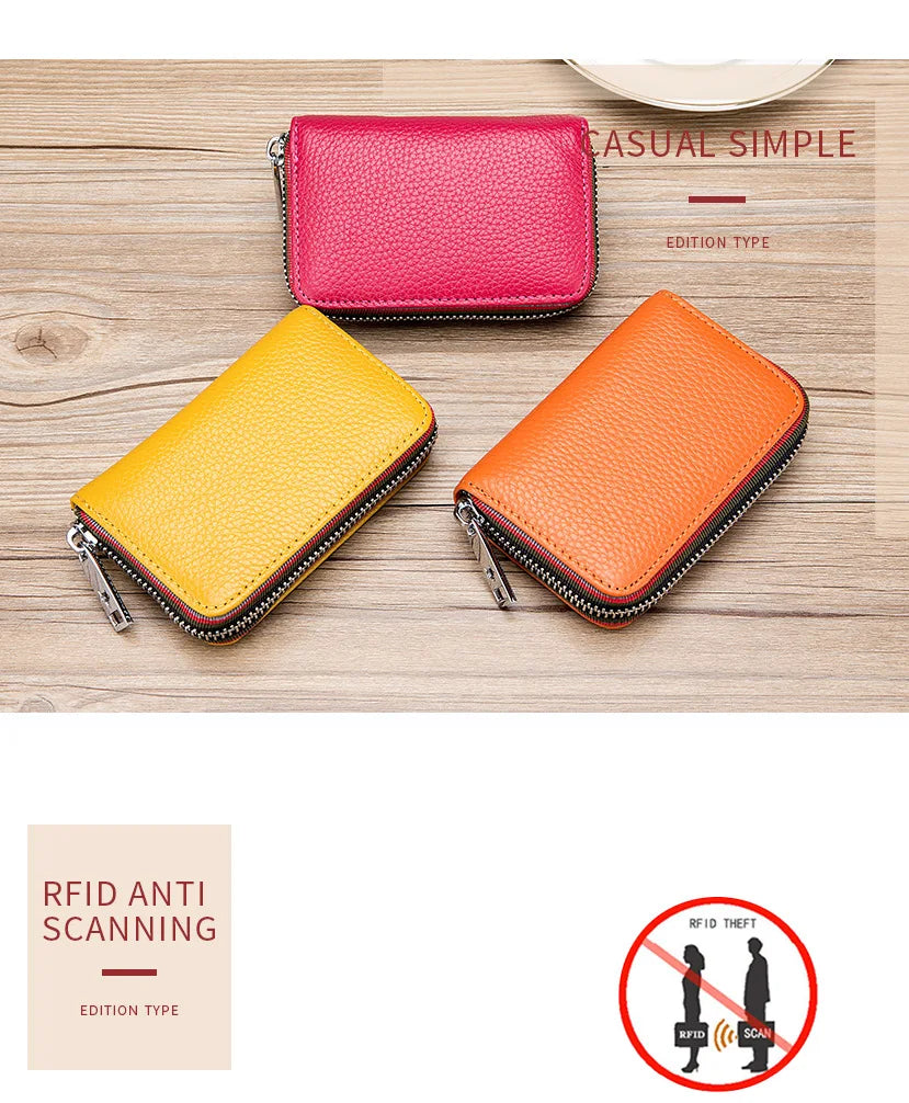 Two genuine leather accordion card holder wallets in pink and orange colors displayed on a wooden surface.