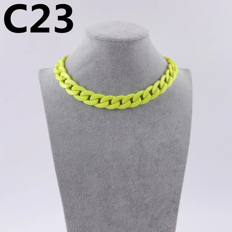 A bright yellow acrylic link chain necklace displayed on a mannequin neck.