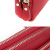 Close-up of a red genuine cowhide leather double-zip wristlet wallet showing the stitching and hardware.