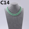 A close-up of a light green acrylic link chain necklace displayed on a mannequin neck.