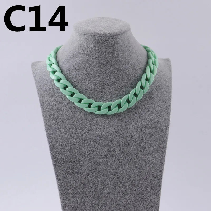 A close-up of a light green acrylic link chain necklace displayed on a mannequin neck.