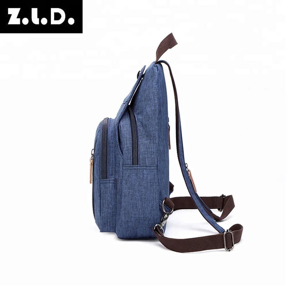 A dark blue canvas backpack with brown straps shown against a white background.