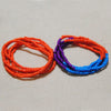 Two strands of colorful belly bead chains, featuring orange and purple beads.