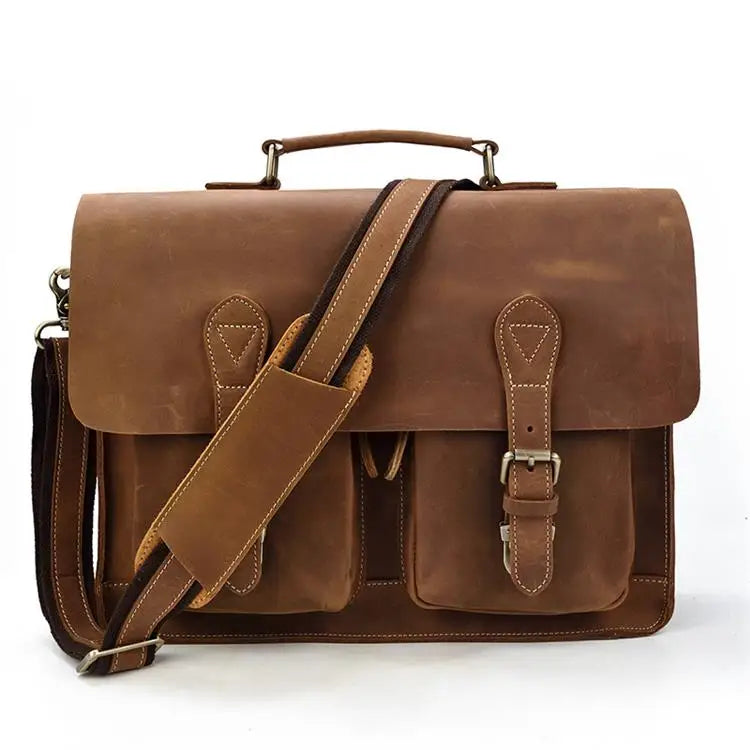 A brown vintage Crazy Horse leather briefcase with a leather strap and laptop compartment.