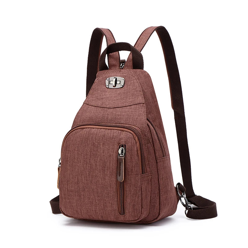 A brown canvas backpack with black straps and a zipper pocket is shown against a white background.