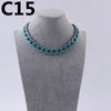 A turquoise acrylic link chain necklace displayed on a mannequin neck.