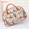 A large beige and brown patterned PU leather travel duffel bag featuring Eiffel Tower illustrations.