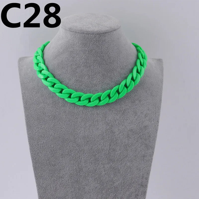 A bright green acrylic link chain necklace displayed on a gray mannequin neck.
