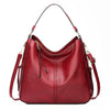 A deep red vintage faux leather hobo shoulder bag with gold hardware.
