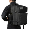 A black tactical backpack with a MOLLE system and laptop compartment is shown from the back.