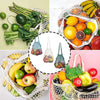A collection of fresh fruits and vegetables like bananas, citrus, avocados, and leafy greens displayed in a woven mesh grocer