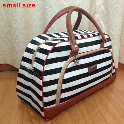 A small black and white striped PU leather travel duffel bag with brown leather handles.