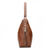 A brown vintage faux leather hobo shoulder bag with a vertical zipper and leather strap.