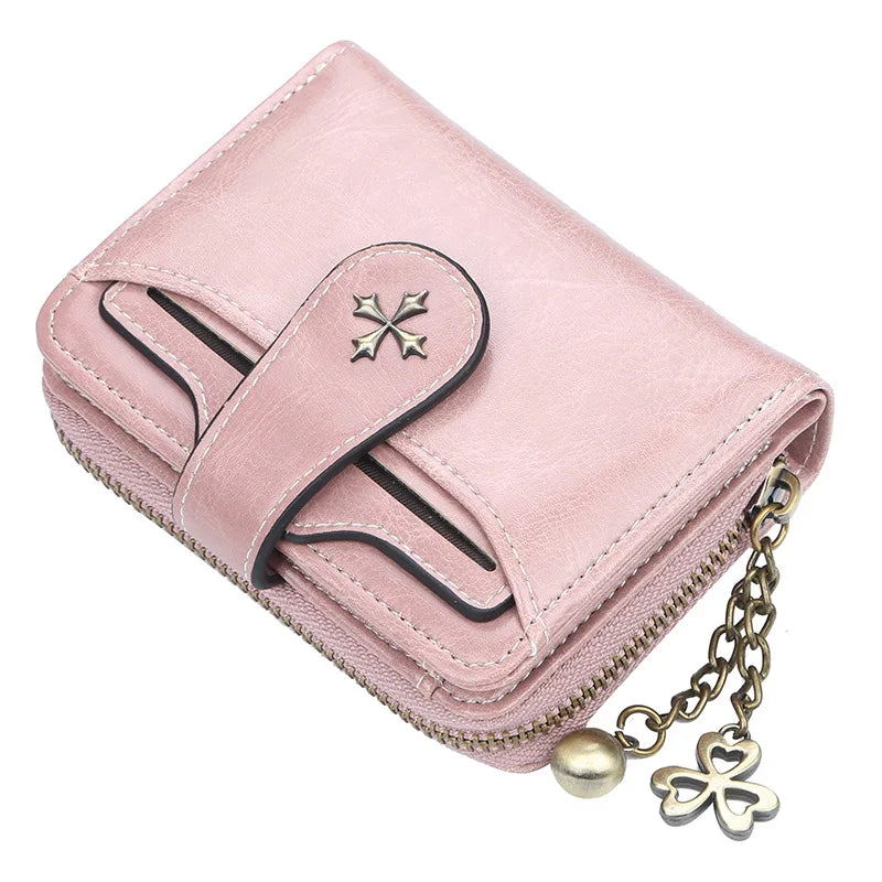 A pink PU leather compact wallet with a zipper closure and a gold-toned chain attached.