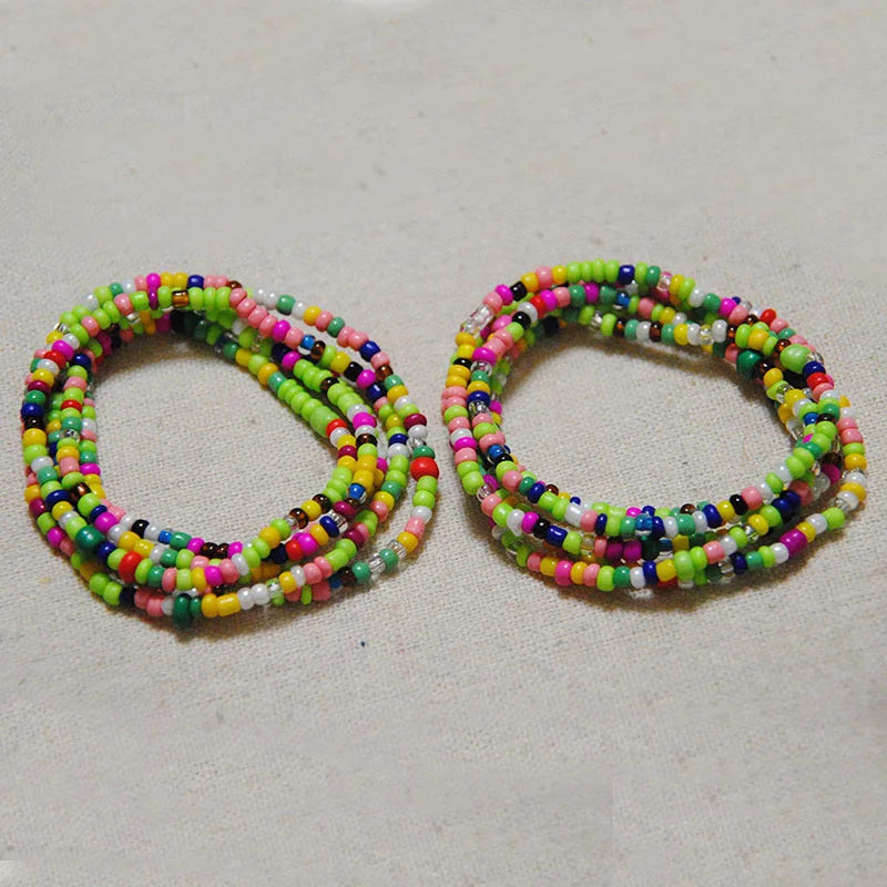 Two strands of colorful belly bead chains featuring mixed pink, green, and blue beads.