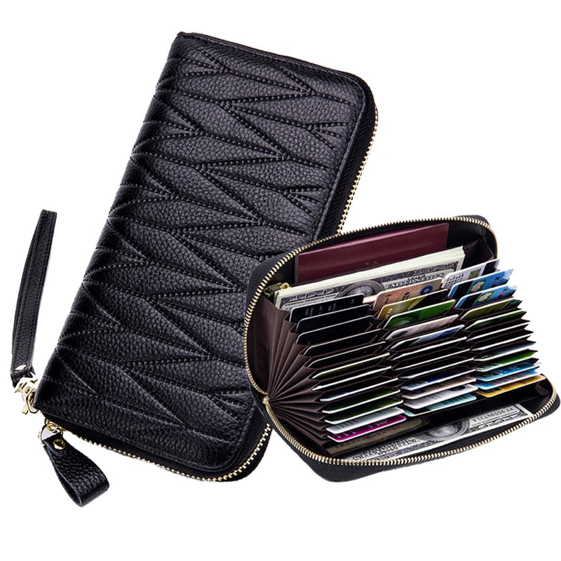 Black genuine leather RFID women's travel wallet with zipper closure displaying various credit cards and IDs