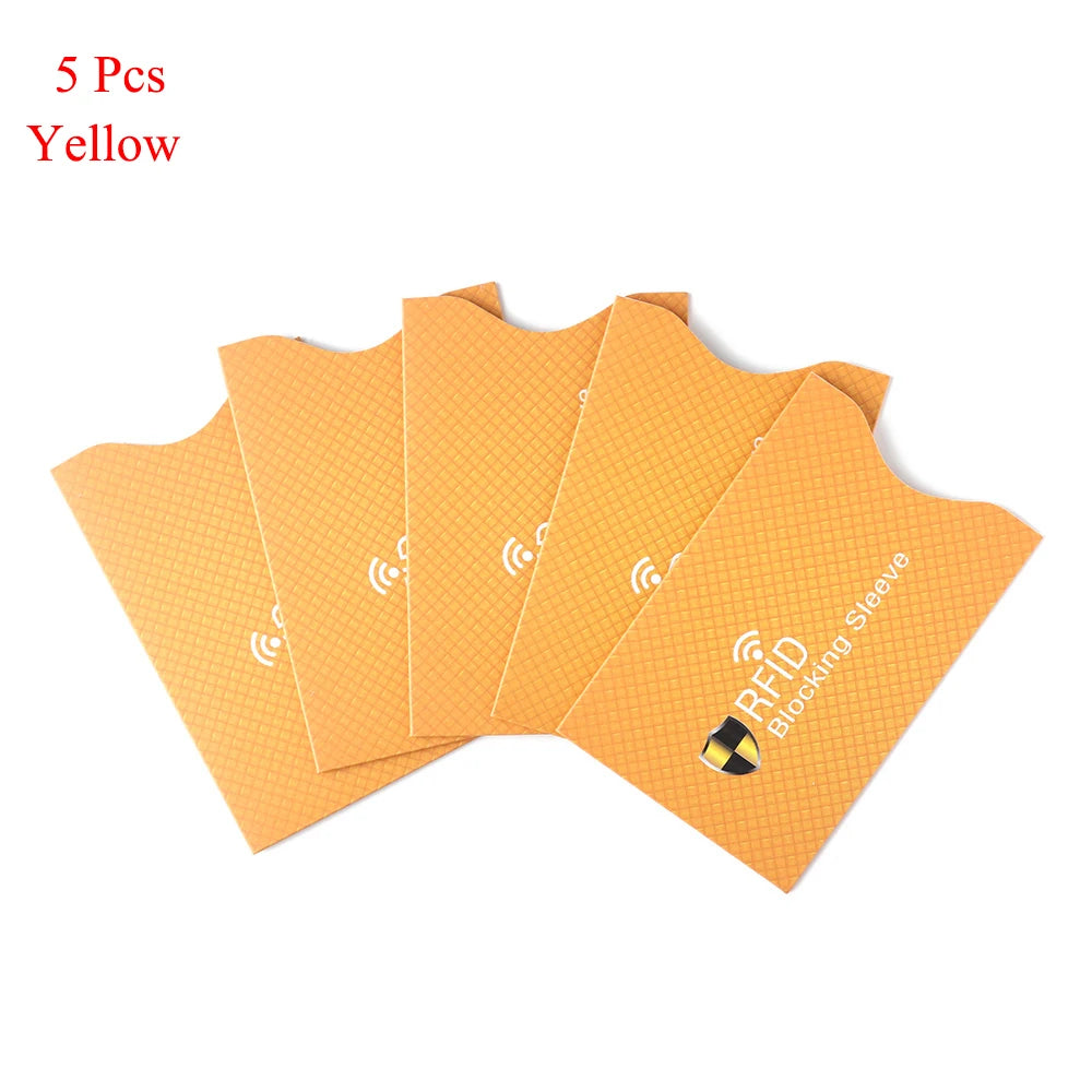 Five yellow RFID blocking card sleeves laid out side by side.