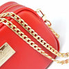 A red leather bag featuring a gold-tone metal chain strap and clips.