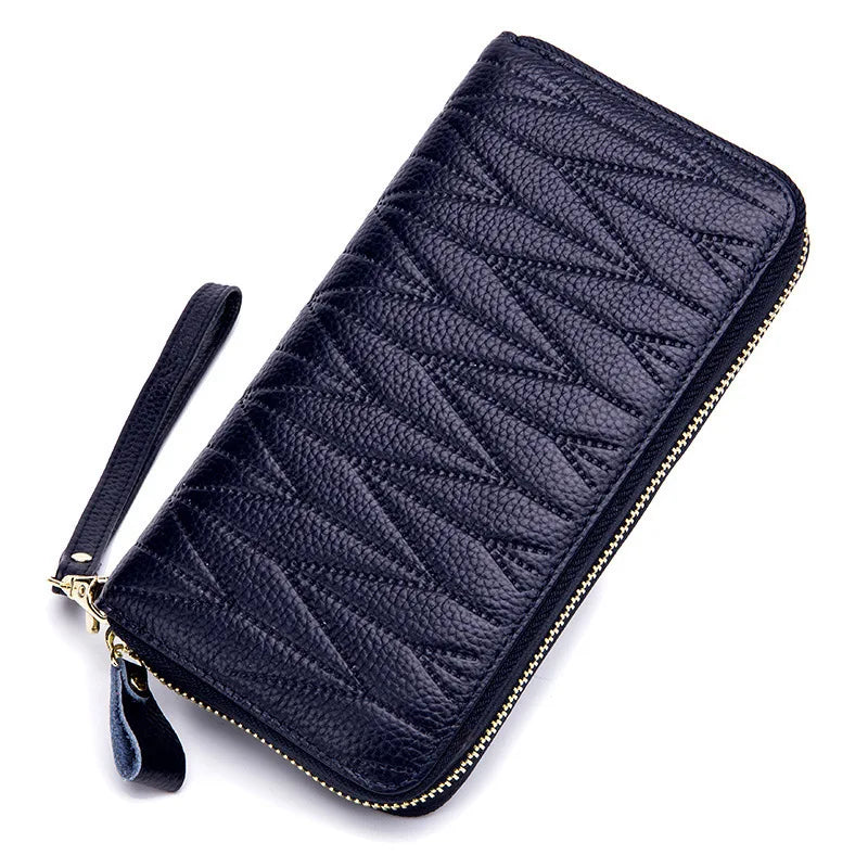A dark navy quilted leather travel wallet with a zipper closure.