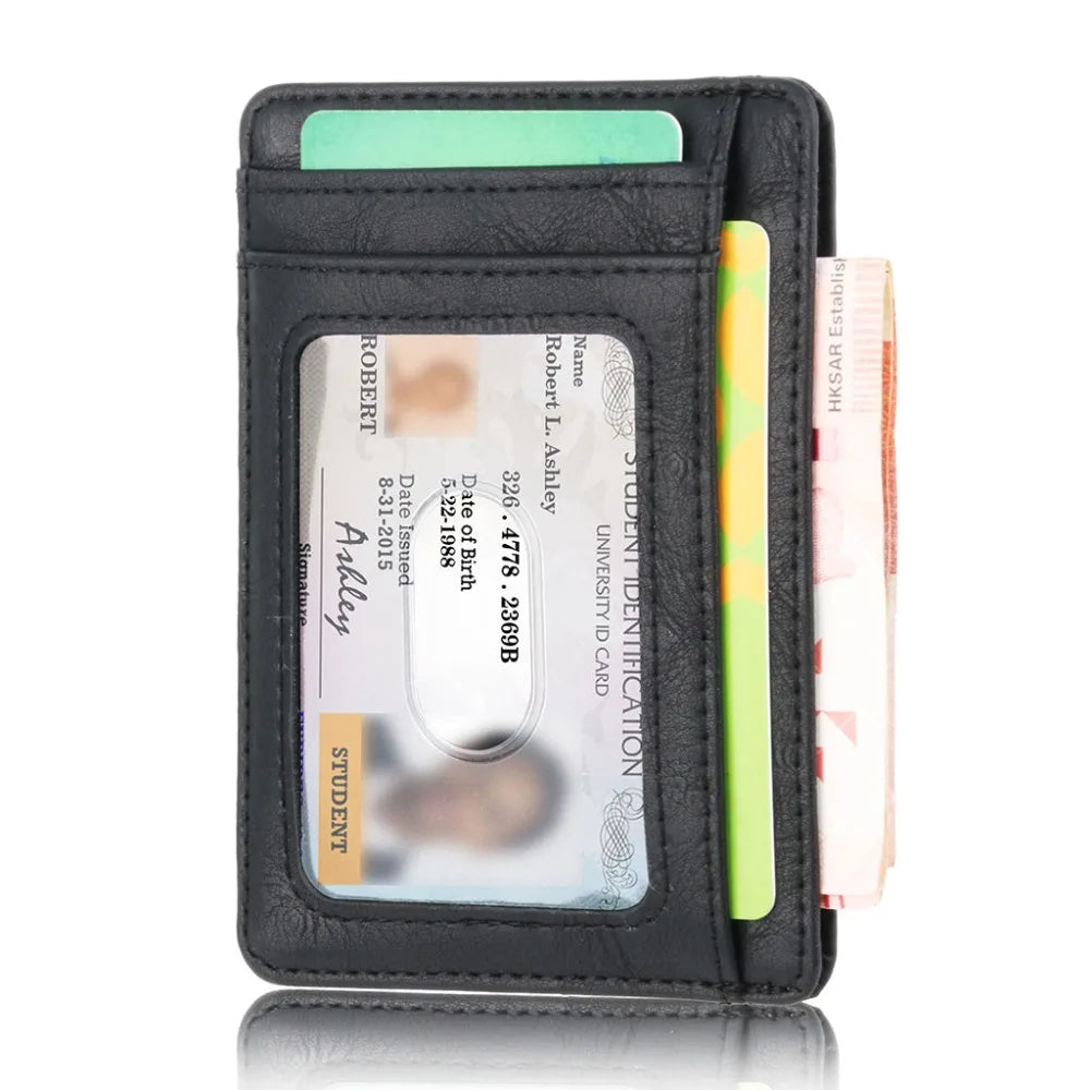 A black leather card holder wallet with a green sleeve and a yellow pen inside.