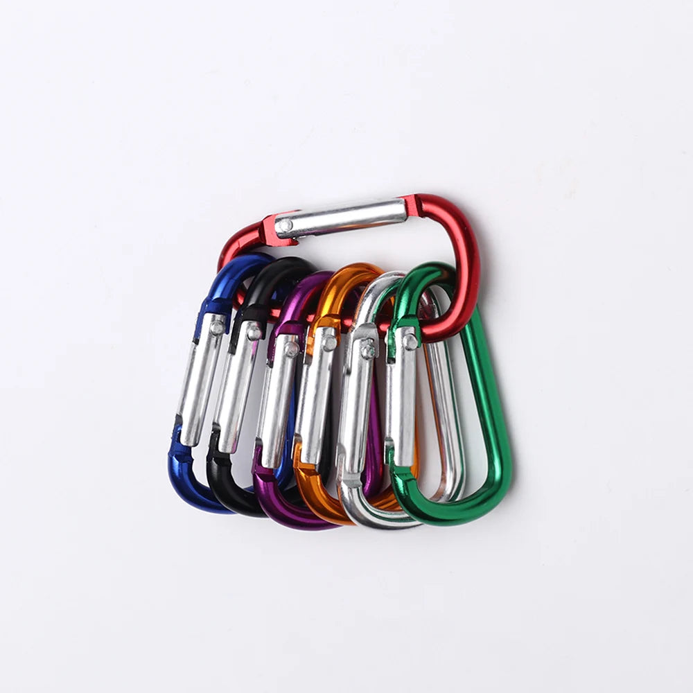 A collection of colorful aluminum carabiner hooks arranged in a row.