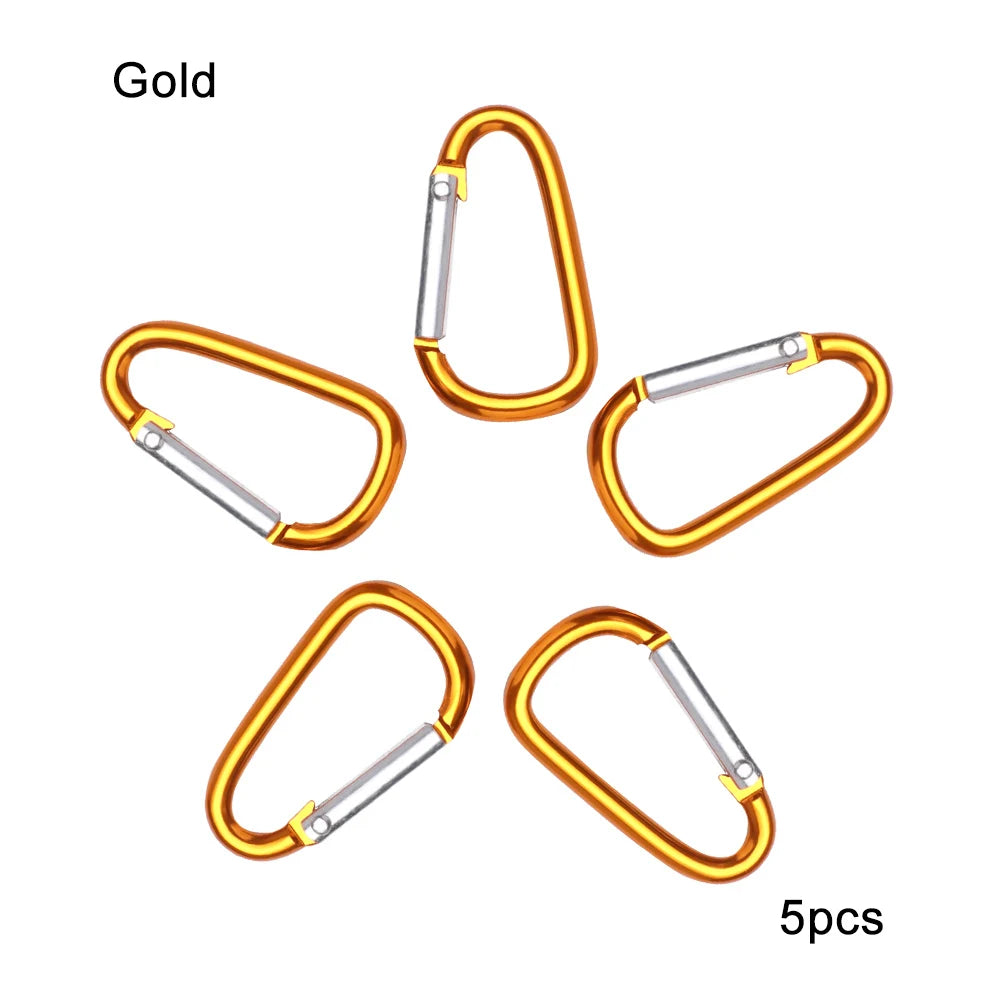 Five gold-colored aluminum carabiner key rings shown individually.
