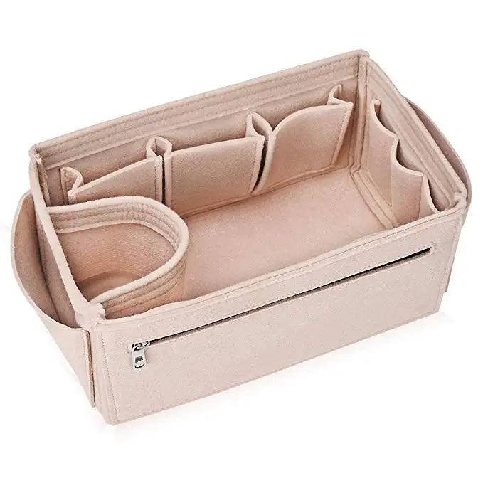A light pink collapsible felt cosmetic organizer pouch with a zipper and divided compartments.