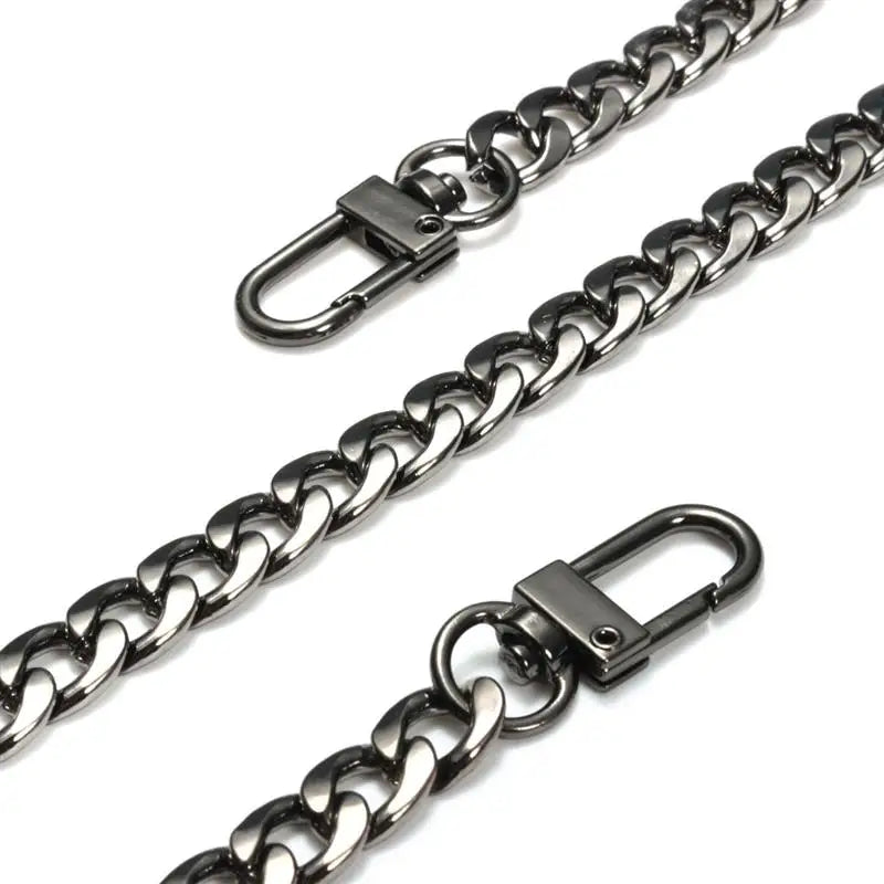 A close-up view of a silver metal bag chain strap with clips.