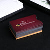 A stack of maroon RFID blocking card sleeves is placed on a black surface.