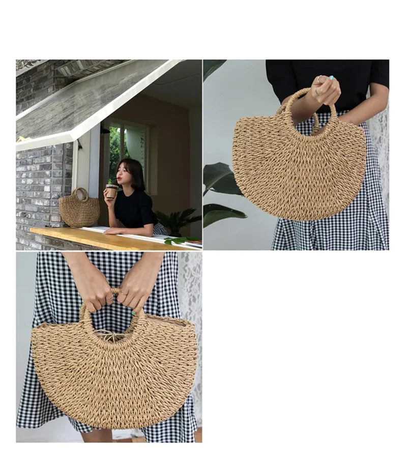 A woman holds a large, handwoven straw moon bag with a top handle against a light background.