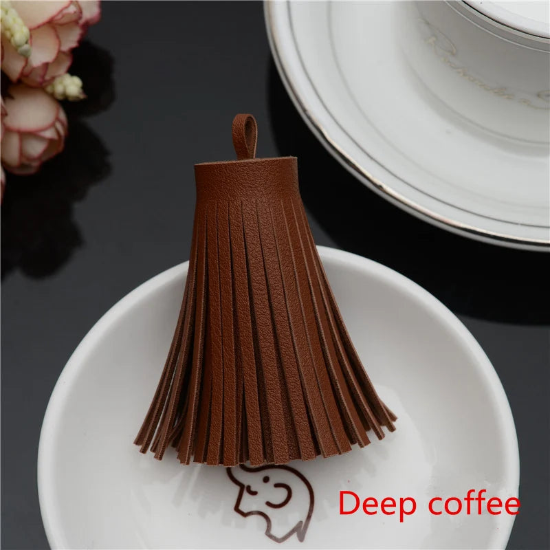 A dark brown leather tassel fringe craft supply set displayed on a white plate.