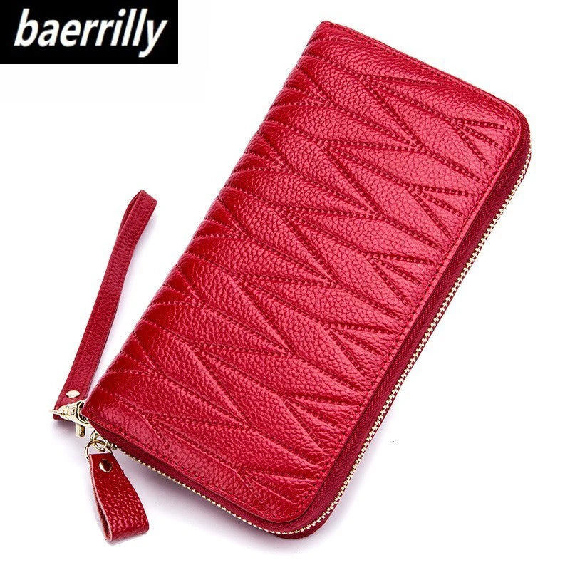 A red quilted leather travel wallet with a zipper closure.