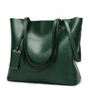 A dark green waxed leather bucket bag with dual straps shown from the front.