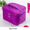 A purple quilted cosmetic storage box with a zipper and a decorative clasp is shown on a white surface.