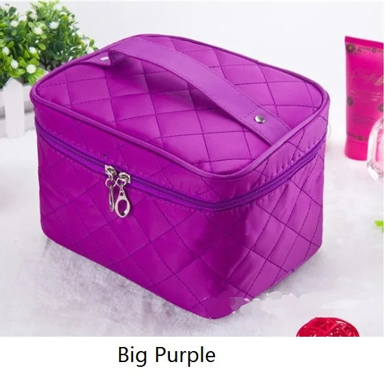 A purple quilted cosmetic storage box with a zipper and a decorative clasp is shown on a white surface.