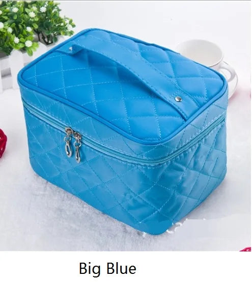 A blue quilted cosmetic storage box with a silver clasp is shown on a white surface.