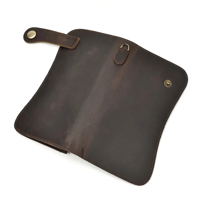 A dark brown genuine leather bifold wallet with a stitched flap and a metal chain attached.
