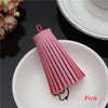 Pink leather tassel fringe craft supplies set resting on a white plate