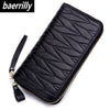 Black genuine leather RFID women's travel wallet with a zipper closure shown diagonally.