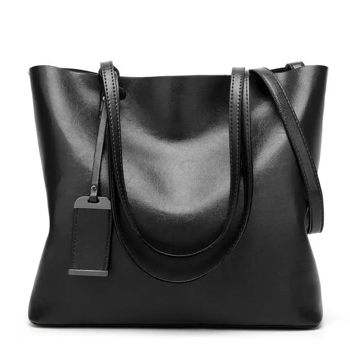A black waxed leather bucket bag with dual straps shown from the front.
